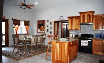 a kitchen with a dining table and chairs , as well as a stove and refrigerator at Lucina's