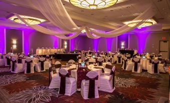 a large banquet hall with multiple tables covered in white tablecloths and chairs arranged for a formal event at DoubleTree by Hilton Hotel Pittsburgh - Green Tree