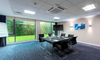 a conference room with a long table , chairs , and a large window overlooking a field at Holiday Inn Express Burnley M65, Jct.10