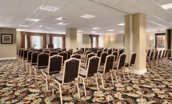 a conference room with rows of chairs arranged in a semicircle , ready for a meeting at Homewood Suites by Hilton Newtown - Langhorne