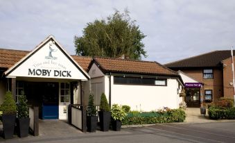 "a small building with a sign that reads "" toby dick "" is located in a parking lot" at Premier Inn London Romford West