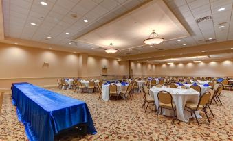 a large banquet hall with multiple tables set up for a formal event , possibly a wedding reception at The Chateau Resort