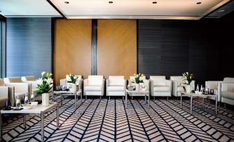 a large room with white couches and chairs arranged in a circle , creating a comfortable seating area at Park Hyatt Doha