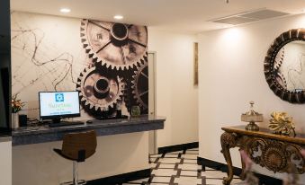 a modern office interior with white walls , black and white checkered floor , a large clock mural on the wall , and a wooden desk with at SureStay Hotel by Best Western Vientiane
