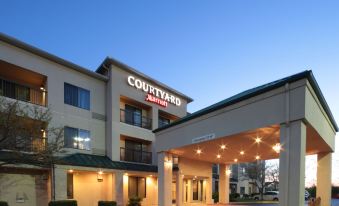 a courtyard by marriott hotel with its entrance lit up and a moon in the sky at Courtyard Dayton North
