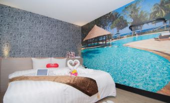 a bedroom with a large bed and a wall mural of a swimming pool , surrounded by various items at 101 Hotel