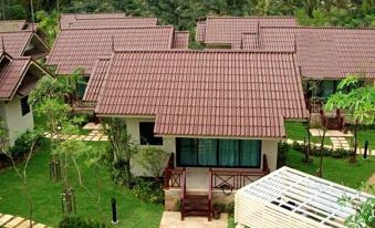a bird 's eye view of a house with a red tile roof surrounded by greenery at Kuiburi Hotel & Resort
