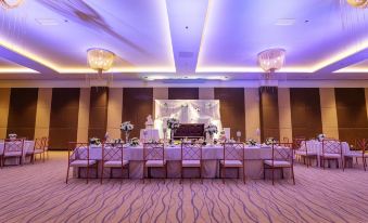 a large banquet hall with multiple dining tables and chairs arranged for a formal event at Summit Hotel Tacloban