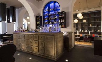 a bar with a wooden counter and shelves filled with various bottles of liquor , creating an inviting atmosphere at Rome Times Hotel