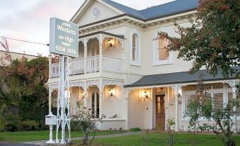 "a large white house with a sign that reads "" the windham on high "" in front of it" at Windarra on High