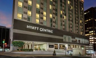 the hyatt centric hotel , a large building with the name lit up in white letters above its entrance at Hyatt Centric Arlington