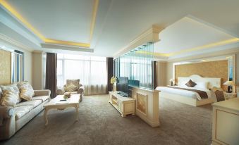 a luxurious hotel room with a king - sized bed , a large flat - screen tv , and a dining table at Muong Thanh Grand Quang Nam