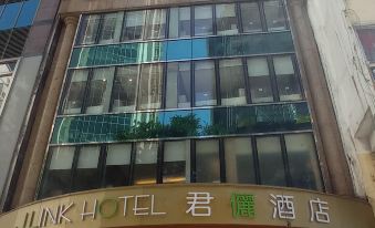The front entrance of a hotel in Hong Kong, featuring a sign above it at J Link Hotel