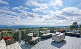 a rooftop deck with several couches and chairs arranged for relaxation , overlooking a beautiful view at Home2 Suites by Hilton Dickson City Scranton
