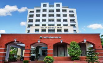 "a red brick building with a sign that reads "" hotel grand park "" on the front" at Hotel Grand Park Barishal