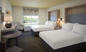 a hotel room with two beds , one on the left side and the other on the right side of the room at Holiday Inn Allentown-Bethlehem