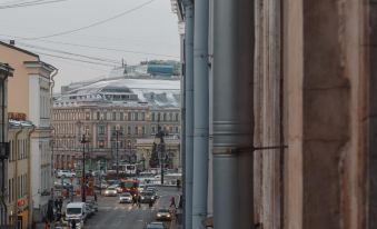 a street view from a high angle with buildings and cars on the side of the road at Fabrika