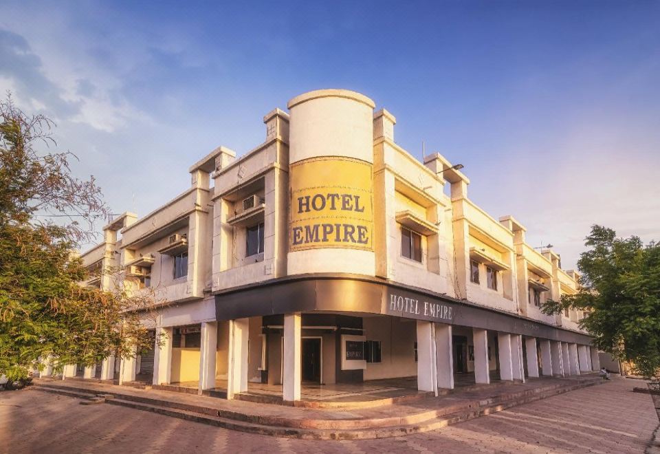 "a large , white hotel building with the name "" hotel empire "" prominently displayed on its facade" at Hotel Empire