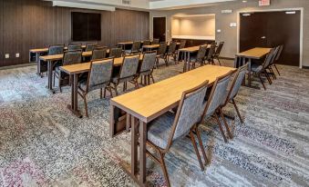a conference room with wooden tables and chairs , a projector screen , and a large screen at Courtyard Troy