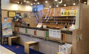 a convenience store with a counter and seating area , providing an inviting atmosphere for customers at Toyoko Inn Aizuwakamatsu Ekimae