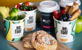"a table with various cups of coffee and pastries , one of which has the word "" re : fuel "" on it" at Aloft Ocean City