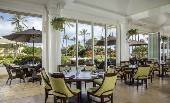a dining room with tables and chairs arranged for a group of people to enjoy a meal at OUTRIGGER Kaua'i Beach Resort & Spa