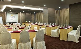 a well - organized conference room with tables and chairs arranged for a meeting or event at Impiana Hotel Ipoh