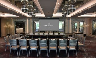 a conference room set up for a meeting , with rows of chairs arranged in front of a projector screen at Dalmeny Park House Hotel