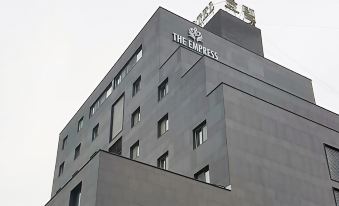 "a large building with a sign that reads "" the empress "" prominently displayed on the side of the building" at The Empress Hotel
