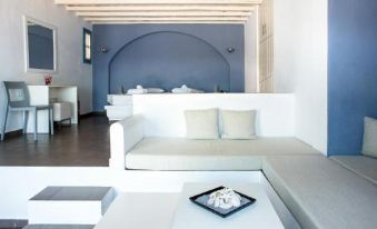 a living room with a white couch , blue wall , and a gray tray on the coffee table at Aeri
