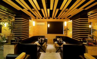 a dimly lit dining room with wooden paneling on the walls , creating a cozy atmosphere at Imperial Heights