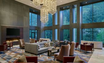 a spacious , well - lit living room with multiple couches and chairs arranged in a comfortable seating area at Grand Hyatt Vail