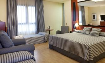 a hotel room with two beds , one on the left and one on the right side of the room at Hotel Olympia Valencia