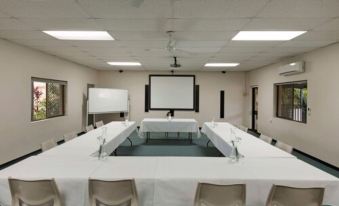 a large conference room with multiple tables and chairs arranged for a meeting or event at Discovery Parks - Ballina