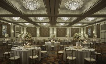 a large , elegant dining room with multiple tables set up for a formal event , each table decorated with flowers and candles at Four Seasons Resort Oahu at Ko Olina