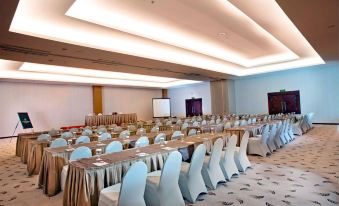 a conference room set up for a meeting , with tables and chairs arranged in rows at Grand Artos Hotel & Convention