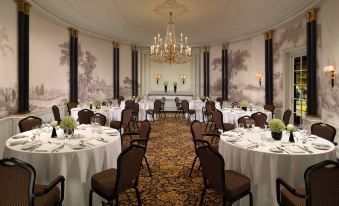 a large , elegant dining room with multiple tables and chairs arranged for a formal event at Hotel Bristol, a Luxury Collection Hotel, Vienna