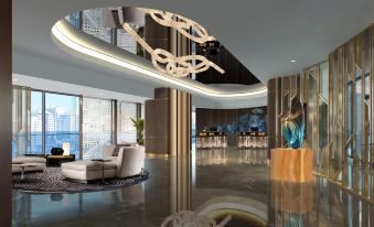 The lobby features a spacious room with an artistic ceiling and floor-to-wall windows at Howard Johnson Plaza by Wyndham Blue Bay Sihanoukville