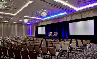 a large conference room with rows of chairs arranged in a semicircle , ready for a meeting at Renaissance Dallas at Plano Legacy West Hotel