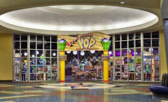 "a large , colorful sign for a store called "" world of pop "" is displayed in the center of a shopping mall" at Disney's Pop Century Resort - Classic Years