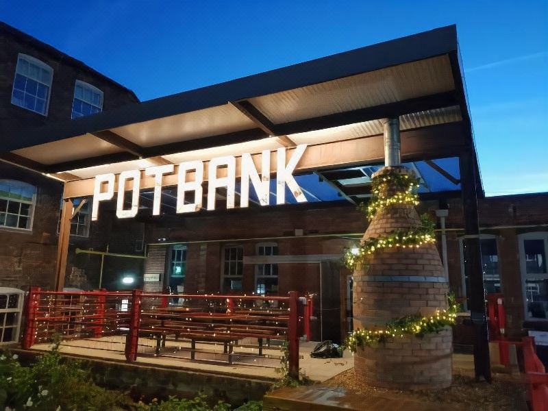 "a brick building with a sign that reads "" pot bank "" prominently displayed on the front" at Potbank