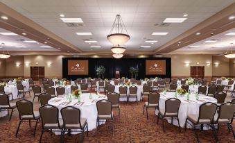 a large conference room with multiple tables and chairs set up for an event , possibly a wedding reception at Great Wolf Lodge Grapevine