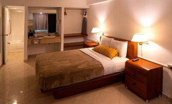 a hotel room with a king - sized bed , a bathroom , and a desk area in the room at Solace by the Sea