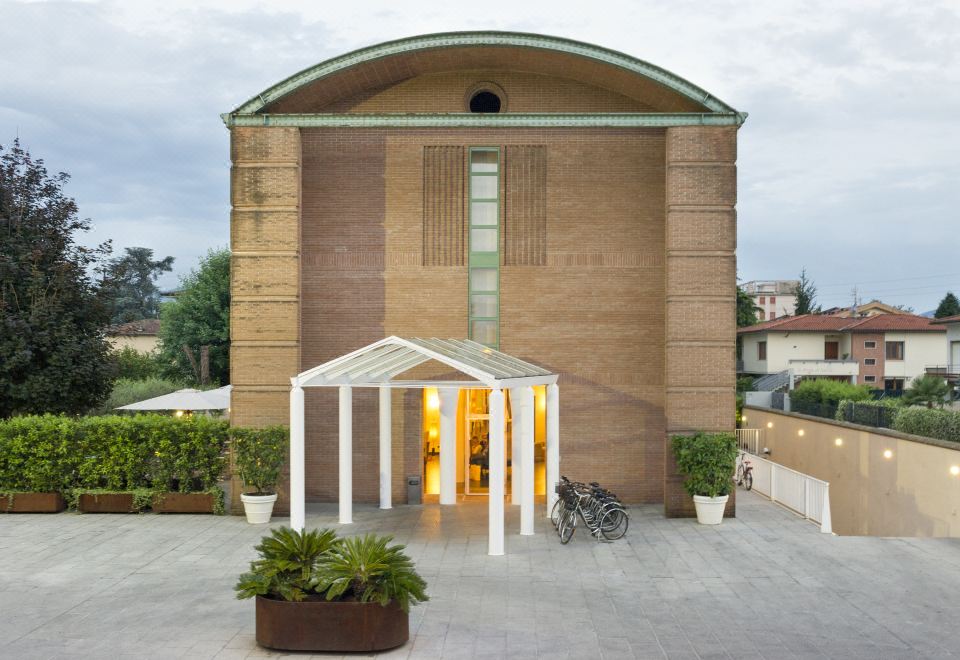 a modern building with a large glass entrance and a bicycle parked in front of it at Hotel San Marco
