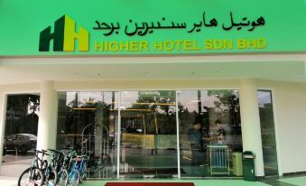 "a building with a sign that reads "" higher hotel sdn bhd "" prominently displayed on the front of the building" at Higher Hotel