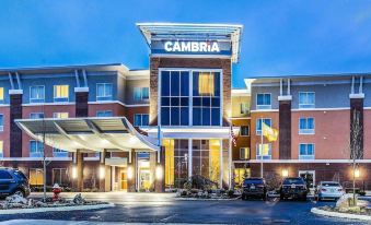 "a large building with a sign that reads "" cambria hotel & suites "" prominently displayed on the front of the building" at Wyndham Avon