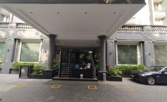 a building entrance with a gray awning and two steps leading up to the entrance at Park Inn by Radisson New Delhi Lajpat Nagar