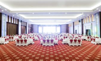 a large , empty banquet hall with rows of tables and chairs set up for an event at Muong Thanh Grand Hoang Mai - Nghe An