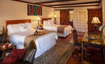 a hotel room with two beds , one on the left side and another on the right side at Tubac Golf Resort & Spa