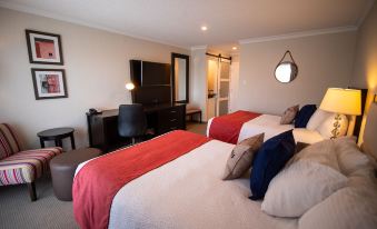 a hotel room with two beds , one on the left and one on the right side of the room at Oak Island Resort & Conference Centre
